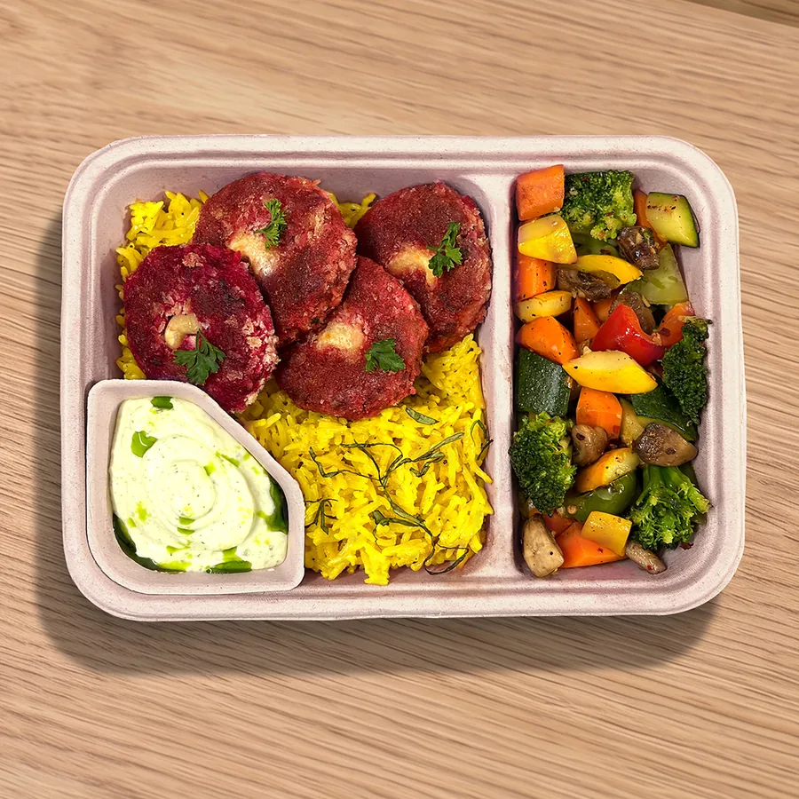 A FOJO tray of beetroot soya tikkis with turmeric rice, sautéed vegetables and a yogurt dip