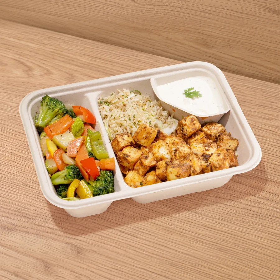 A FOJO tray of chipotle paneer with herb rice, sautéed vegetables and garlic yogurt