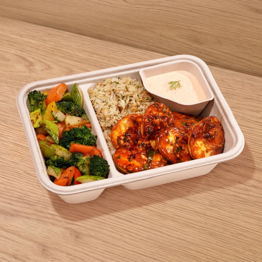 A FOJO tray of peri peri eggs with sautéed vegetables, brown rice and a yogurt dip