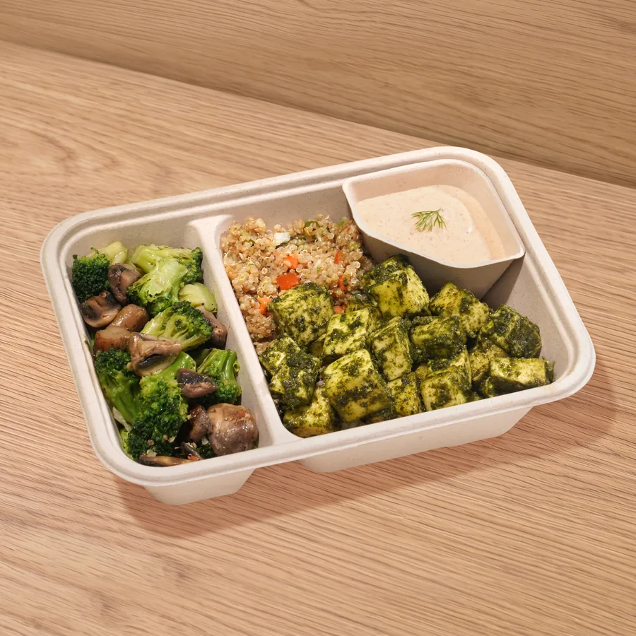 A FOJO tray of pesto paneer with broccoli and mushroom, quinoa and a yogurt dip