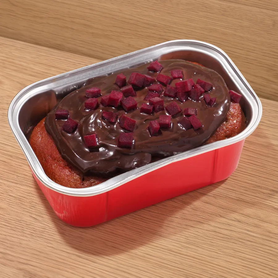 FOJO beetroot cake in its tin, topped with chocolate ganache and beetroot