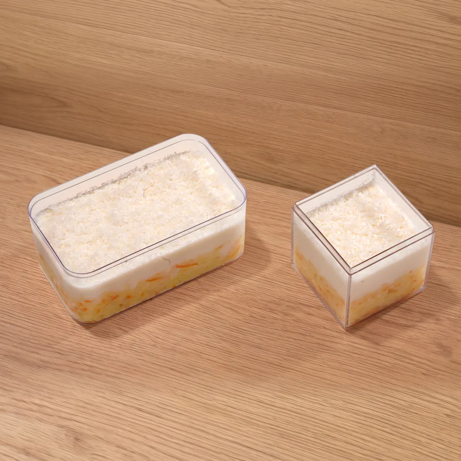 FOJO pudding in a box and a cube, layered with custard and topped with crushed nuts