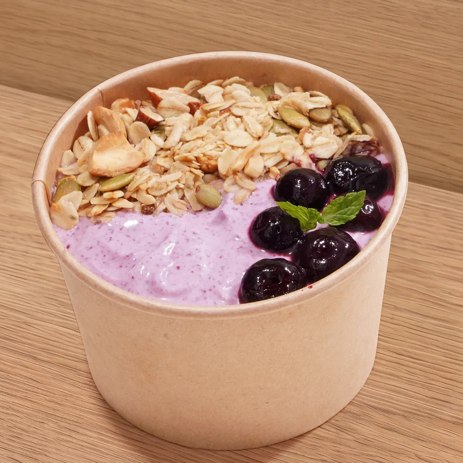 A cup of FOJO blueberry yogurt topped with granola and fresh blueberries